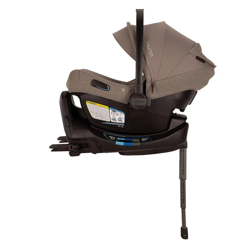 Nuna Triv LX and Pipa Aire RX Travel System in Cedar color, featuring a car seat with a sunshade and base, adjustable support leg, and safety labels.