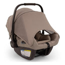 Nuna Triv Lx + Pipa Aire Rx travel system in Cedar color, showcasing the infant car seat with a protective canopy and safety label.