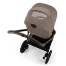 Nuna Triv Lx stroller with a Cedar fabric, featuring a canopy and a black frame, viewed from above.