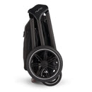 Nuna Triv Lx stroller folded with a black frame and large wheels, showcasing compact design and portability.