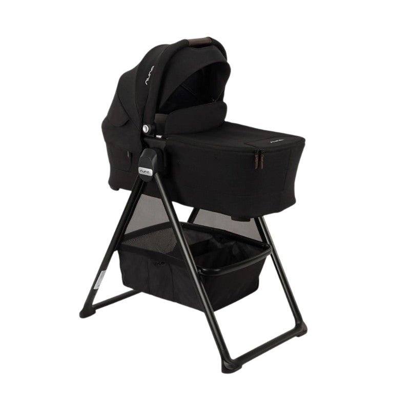 Nuna Triv Lx stroller with Triv bassinet and stand in caviar color, featuring a sleek design and storage basket below.