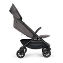 Nuna Trvl 360 Compact Stroller in pewter color, featuring a reclined seat, adjustable handle, and four wheels.
