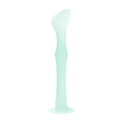 Diaper rash cream applicator in mint color, featuring a suction base for stability during use.