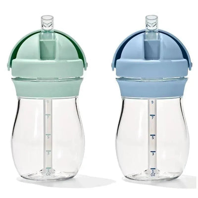Two Oxo 9 oz. Transition Straw Cups in opal and dusk colors with measurement markings visible on each cup.