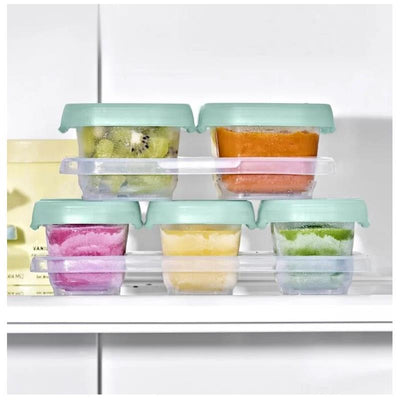 Oxo Tot 12-piece baby food storage container set in opal, featuring colorful fruit purees in stackable containers with green lids.