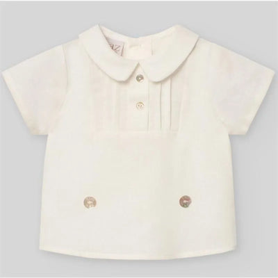Cream short-sleeve newborn shirt features a pleated front, button closure, and rounded collar, designed for baby boys.
