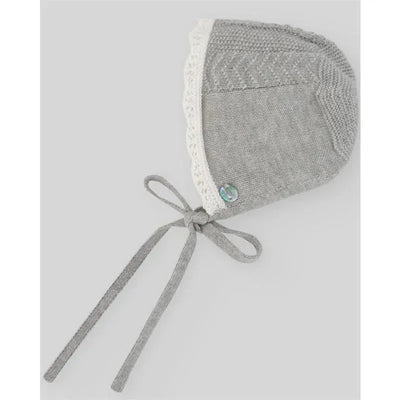 Knit grey baby bonnet with lace trim, featuring a button and ties, designed for newborns.