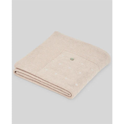 Nectar linen/white Paz Rodriguez blanket featuring a textured weave with small white dots and a decorative button.