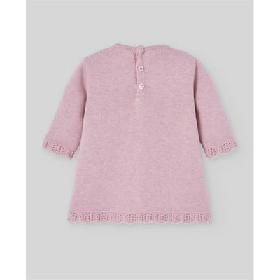 Knit newborn dress in powder pink, featuring three-quarter sleeves, a scalloped hem, and button closure at the back.