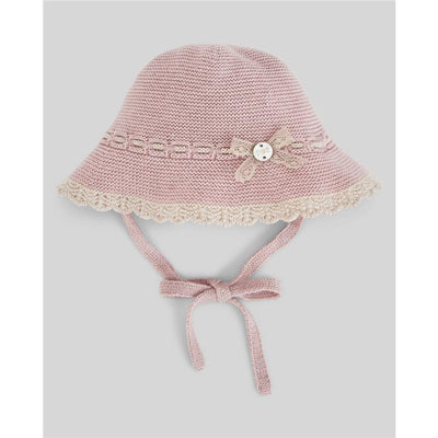 Knit newborn hat in powder pink and light brown, featuring a decorative bow and button, with ties for secure fit.