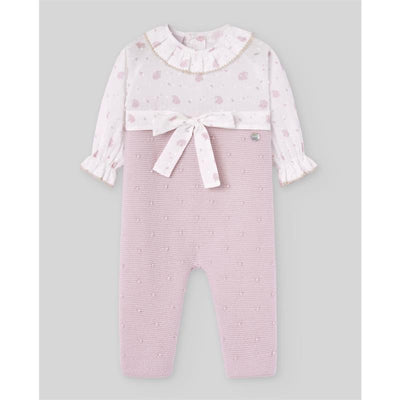 Knit newborn romper in mauve, featuring a floral-patterned top, bow detail at the waist, and textured bottom.