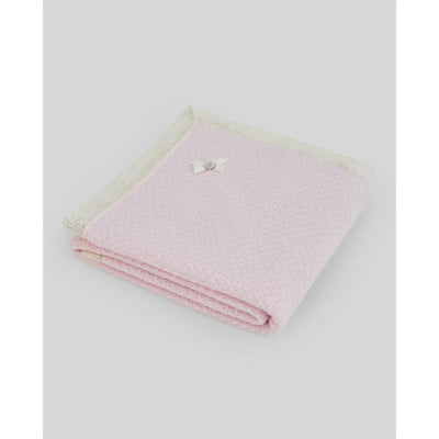 Knit newborn shawl in light pink and cream, featuring a decorative bow, designed for infants.