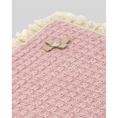 Knit newborn shawl in cream with a textured pattern, finished with a lace trim and a small bow detail.