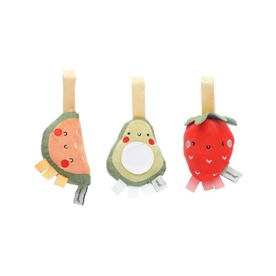 Three cute fabric stroller toys shaped like a slice of watermelon, an avocado, and a strawberry, featuring soft textures and bright colors.