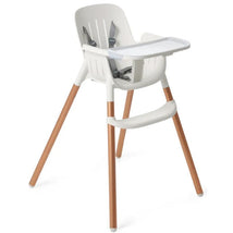 High chair with a white plastic seat and copper-colored legs, featuring a safety harness and a removable tray.