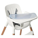 High chair with a white seat and adjustable safety straps, featuring a clear plastic tray and wooden legs.