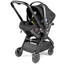Baseless infant car seat in True Black, featuring a sleek design, adjustable handle, and safety harness system.