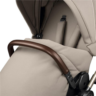 Peg Perego Vivace stroller in Astral beige, featuring a brown handlebar and soft fabric cover for comfort.