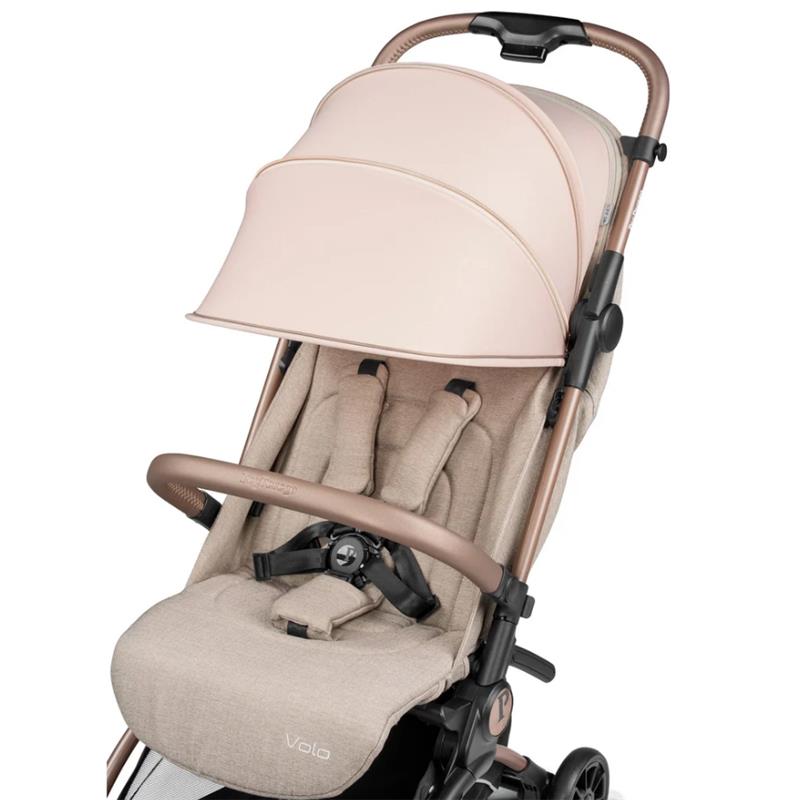 Compact Peg Volo stroller in Mon Amour Rose Gold with a large canopy and beige fabric seat, featuring safety harness and armrest.