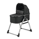 Peg Perego Ypsi Bassinet in True Black on a stand; features a soft hood and sturdy metallic frame.