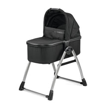 Peg Perego Ypsi Bassinet w/Stand by Me 2025 in True Black, featuring a padded mattress and a sleek metal frame.