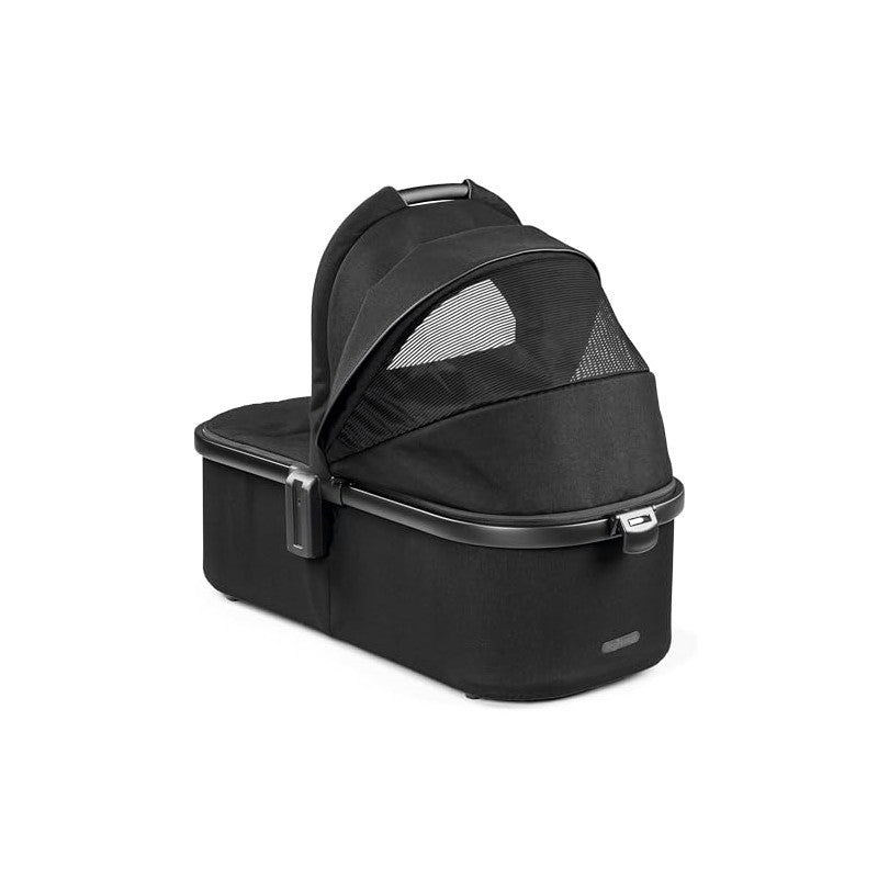 Ypsi Bassinet by Peg Perego in True Black with a removable canopy and mesh panels for ventilation.