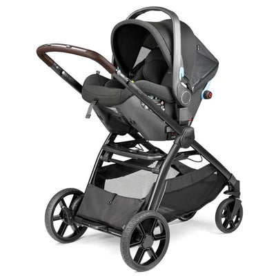 Peg Ypsi Single-to-Double Stroller in True Black featuring a car seat attachment, adjustable handle, and spacious storage basket.