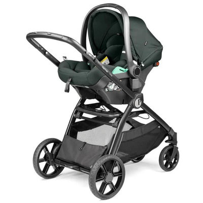 PEG YPSI + Primo Viaggio Nido Travel System in metal, featuring a dark green infant seat atop a black stroller frame with large wheels.