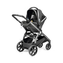 Peg Perego Ypsi Travel System in metal, featuring a stroller with a car seat attached, designed for infant transport.