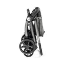 Peg Perego Ypsi Travel System in a folded position, showcasing its compact design and sturdy wheels.