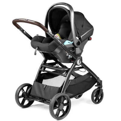 Travel system features a black stroller with a car seat, brown handle, and a spacious mesh storage basket.