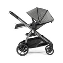 Peg Perego Ypsi Travel System in Vanilla Blend, showcasing a modern stroller with a foldable canopy and spacious storage basket.