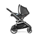 Peg Perego Ypsi Travel System in Vanilla Blend, featuring a stroller with a car seat attachment, sleek design, and a spacious under-basket.