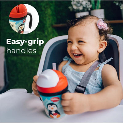 Bamboo fiber kids cup with handle and straw, featuring a penguin design, held by a smiling child in a high chair.