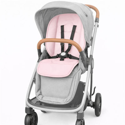 Light pink stroller liner for Primo Passi stroller, featuring a padded seat with adjustable straps and a soft gray frame.