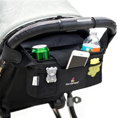 Black Primo Passi baby stroller handle organizer featuring pockets for drinks, a smartphone, and toys.