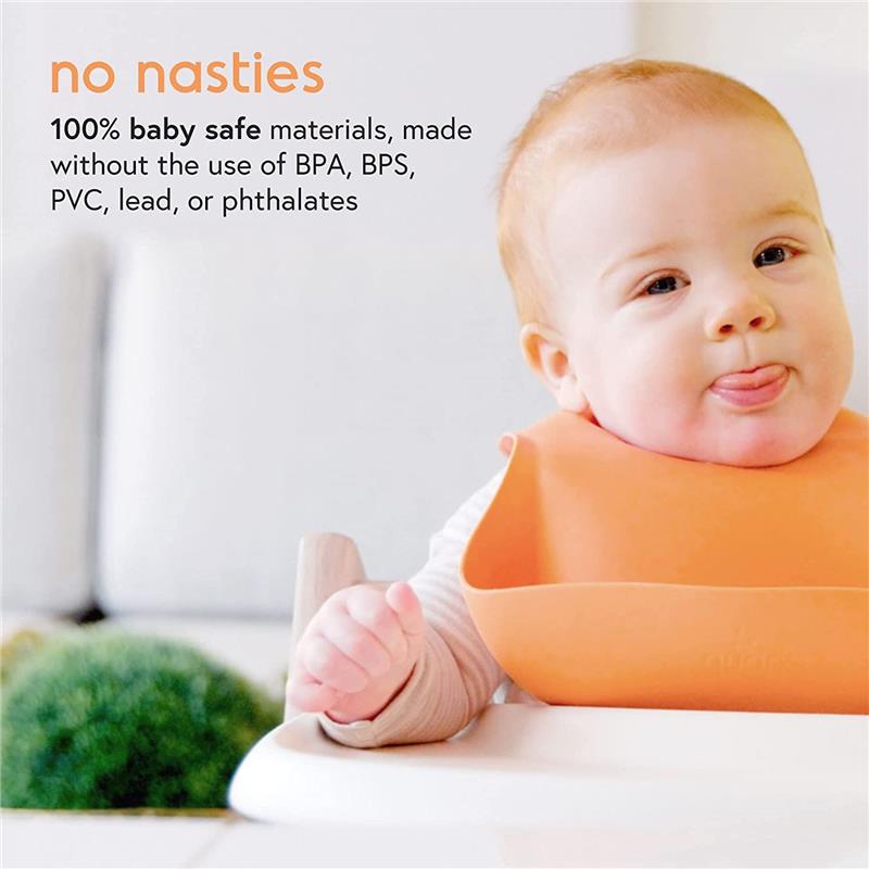 Baby in a high chair wearing an orange bib, sticking out tongue; text highlights baby-safe materials without harmful chemicals.