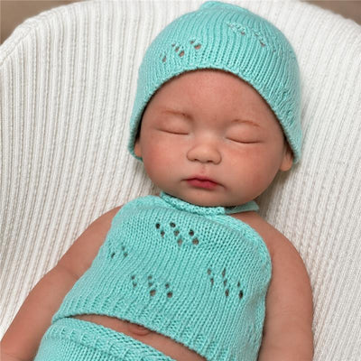 Reborn baby doll named Chloe, 16 inches, closed eyes, no hair, wearing a mint green knitted outfit and hat.