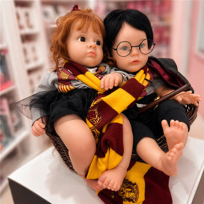 Reborn Baby Doll set featuring a girl with red hair and a boy with black hair, both in Hogwarts attire with scarves.