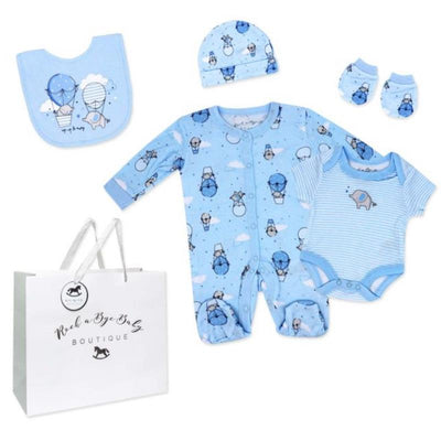 Five-piece baby boys mesh bag set featuring light blue clothing with hot air balloon designs, including a romper, bodysuit, bib, hat, and socks.