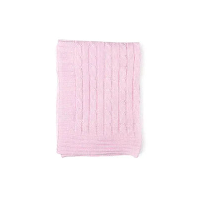 Cable knit blanket in soft pink, showcasing textured patterns and a cozy design ideal for warmth and decor.