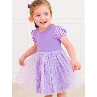 Baby girl smiling while wearing an amethyst short sleeve dress with striped sleeves and a twirl skirt, in a bright setting.