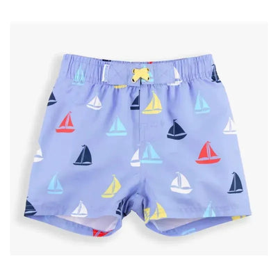 Blue swim trunks featuring a colorful sailboat pattern in red, yellow, blue, and white, ideal for summer wear.