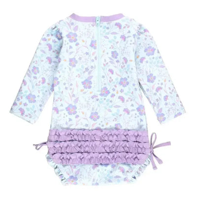 Long sleeve rash guard features a fairytale garden floral pattern and a ruffled lavender bottom with a back zipper.