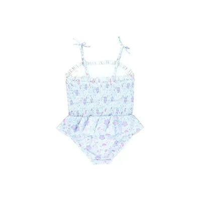 Fairytale Garden peplum one-piece swimsuit featuring a smocked bodice, floral print, and adjustable straps.