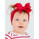 Red headband with a large bow worn by a smiling baby with light hair and blue eyes, dressed in a striped shirt.