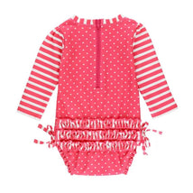 Hot pink long sleeve one-piece rash guard for toddlers, featuring white polka dots and striped sleeves, with a back zipper and ruffled detail.