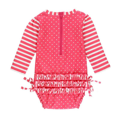 Hot pink long sleeve one-piece rash guard for toddlers, featuring white polka dots and striped sleeves, with a back zipper and ruffled detail.
