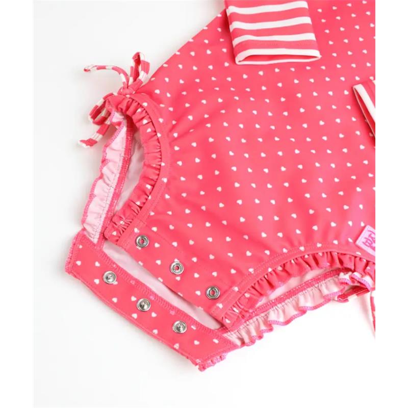 Hot pink heart-patterned long sleeve one-piece rash guard for infants, featuring snaps and ruffled edges.