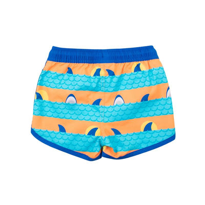 Boys swim trunks featuring blue and orange wave patterns with shark fins and yellow moons, providing UPF 50+ sun protection.
